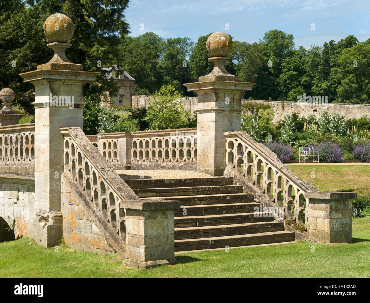 Stone steps, balustrades and pillars of an ornamental bridge in Easton Walled Gardens, Grantham, Lincolnshire, England, UK Stock Photo