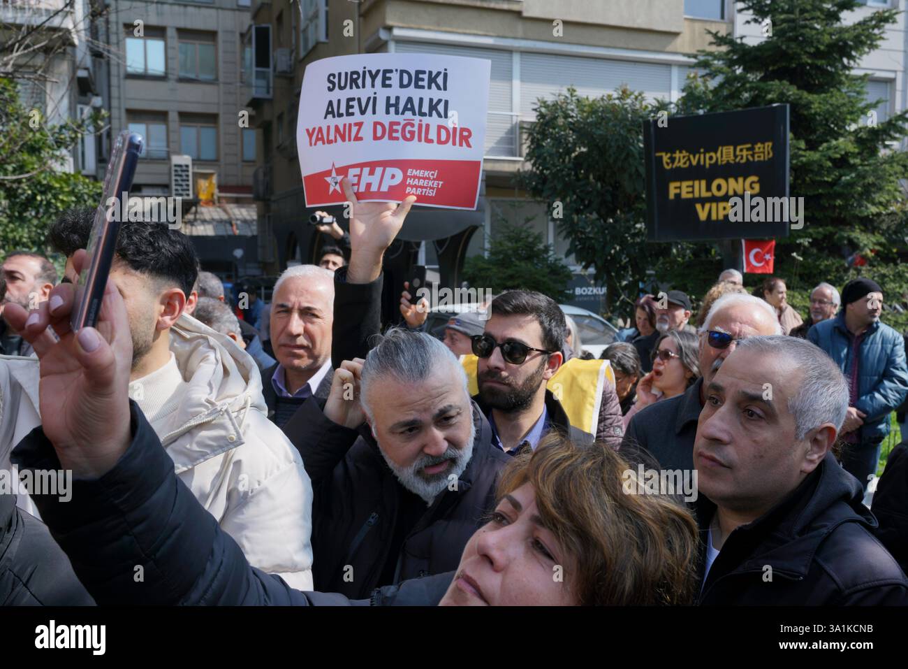 Sisli, Istanbul, Turkey. 9th Mar, 2025. A protester hold placards ''The Alawite people in Syria are not alone.'' during a protest demonstration against the deaths of Alawites in Syria in front of Macka Park near the Syrian Consulate General in Istanbul onÂ MarchÂ 9,Â 2025. (Credit Image: © Tolga Uluturk/ZUMA Press Wire) EDITORIAL USAGE ONLY! Not for Commercial USAGE! Stock Photo