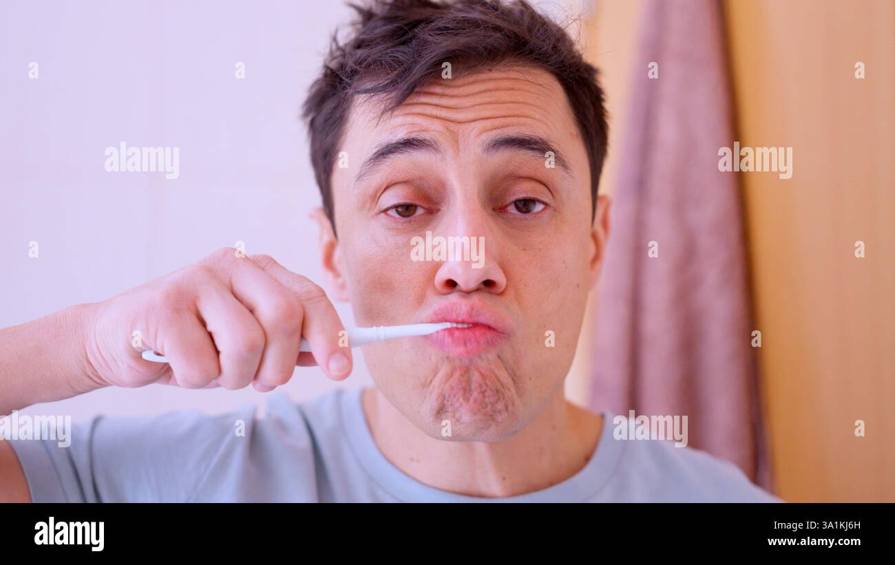 Man brushing teeth in bathroom mirror reflection montage Stock Photo