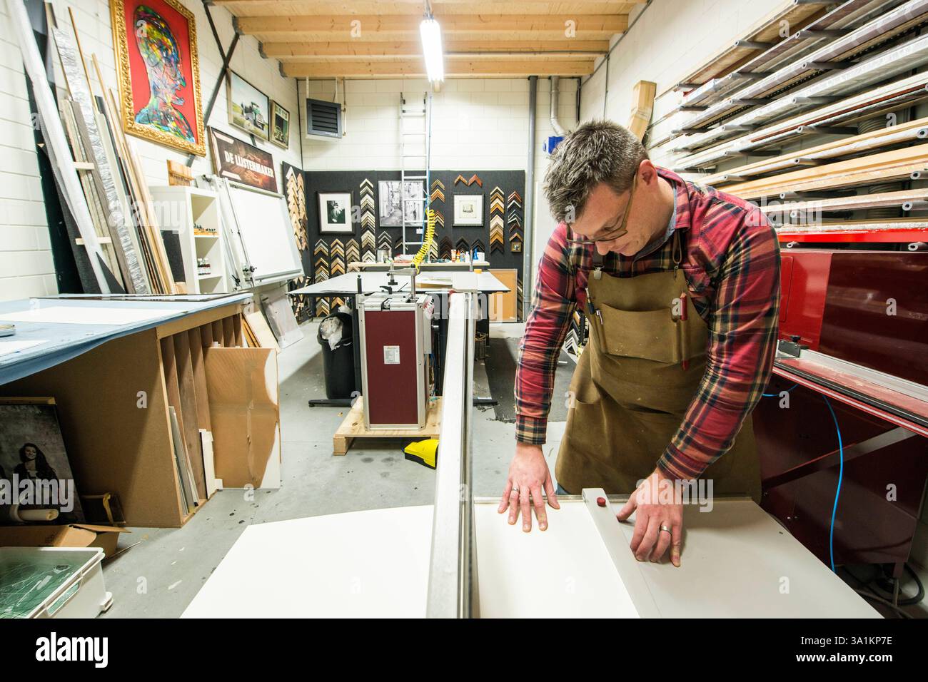 Paper Framemaker Framemaker inside his workshop Goirle, Netherlands. Mid adult male ...
