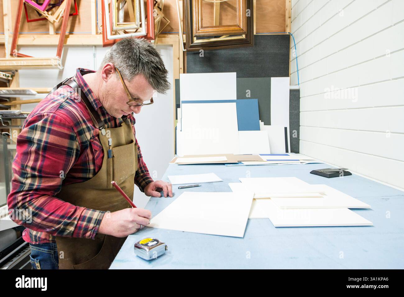 Paper Framemaker Framemaker inside his workshop Goirle, Netherlands. Mid adult male ...