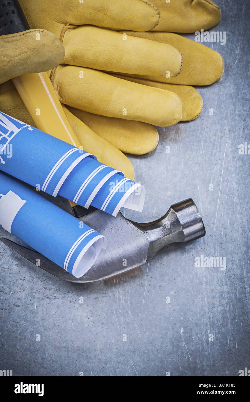 Protective gloves blue rolled up engineering drawings claw hammer Stock ...