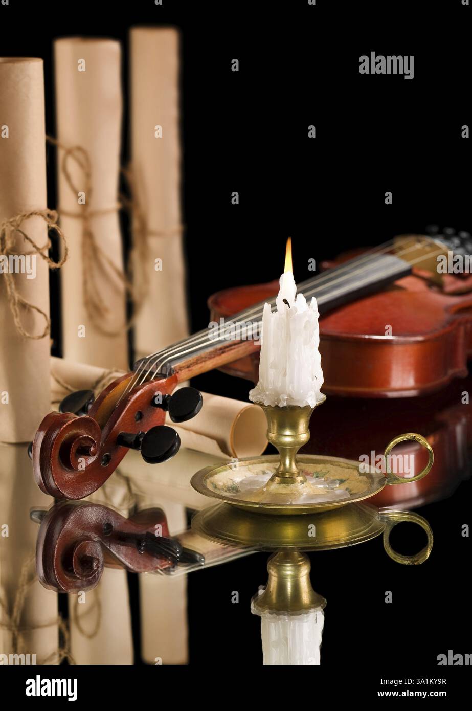 Old violin witn candle ond old scroll of paper Stock Photo