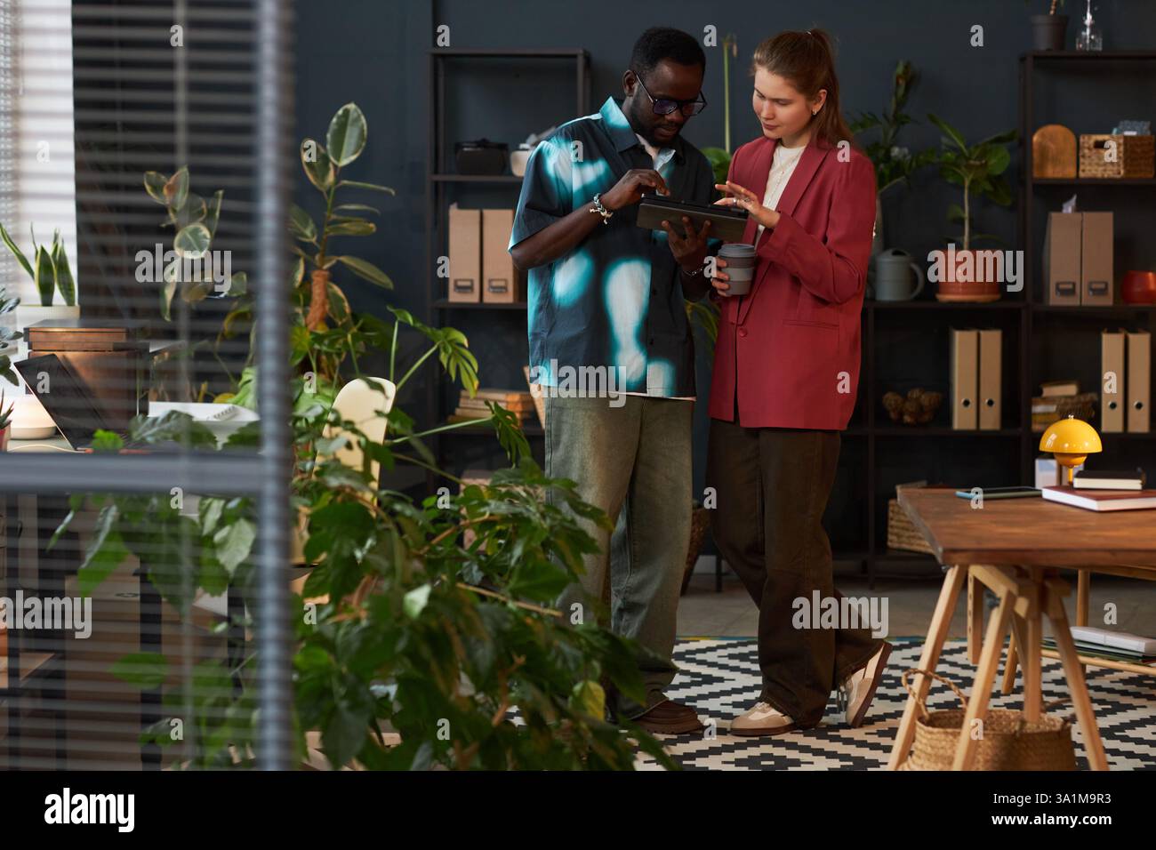 Colleagues Working Together In Eco Office Stock Photo