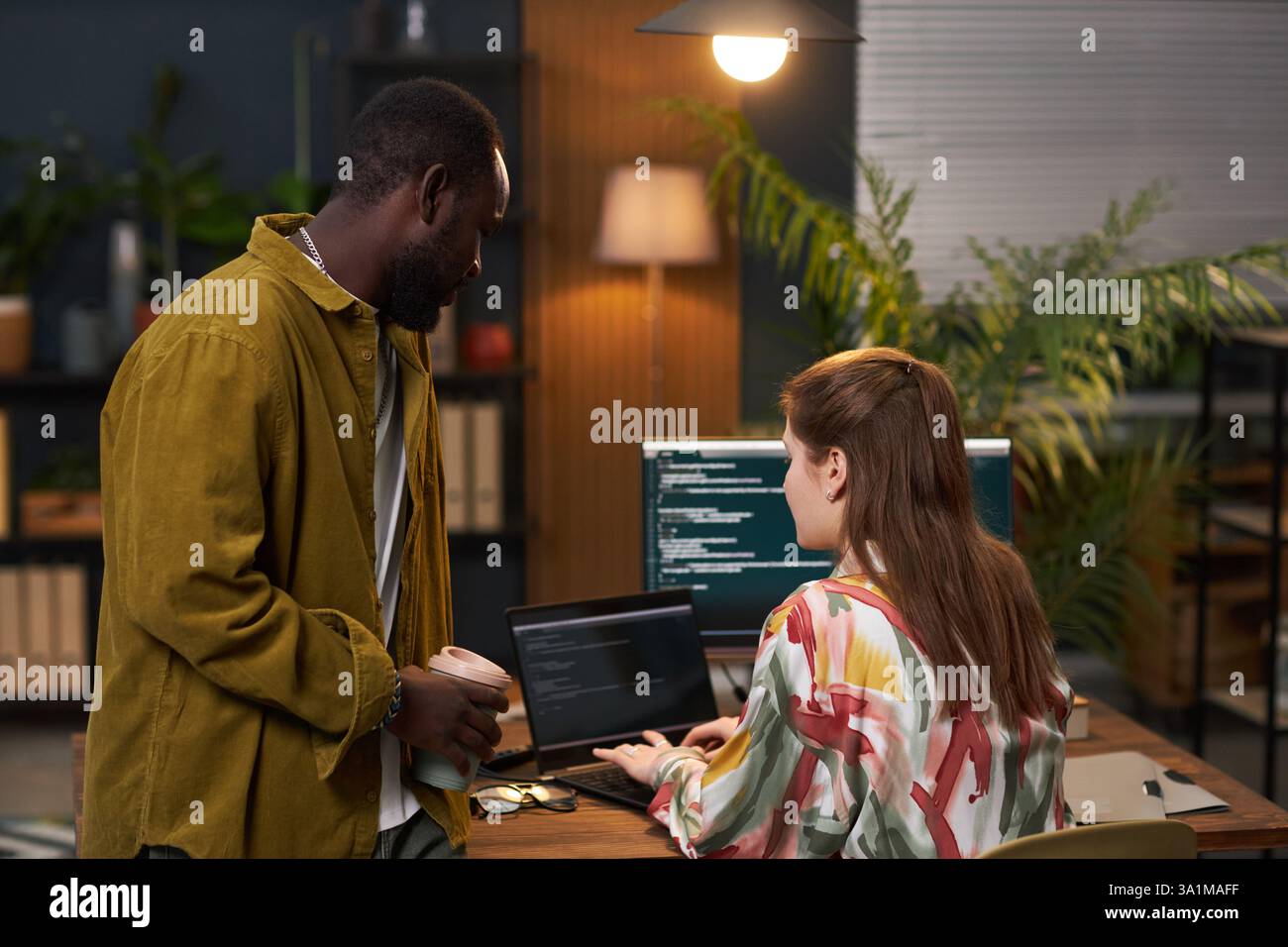 Woman Typing Script On Computer In Office Stock Photo