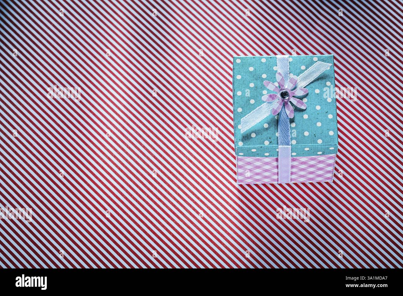 Packed present box on stripy fabric background celebrations concept ...