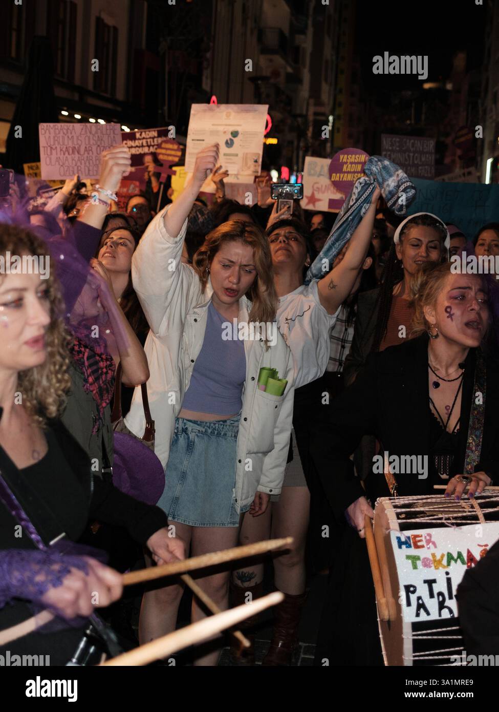 Women chant slogans as the play musical instruments. On March 8 ...