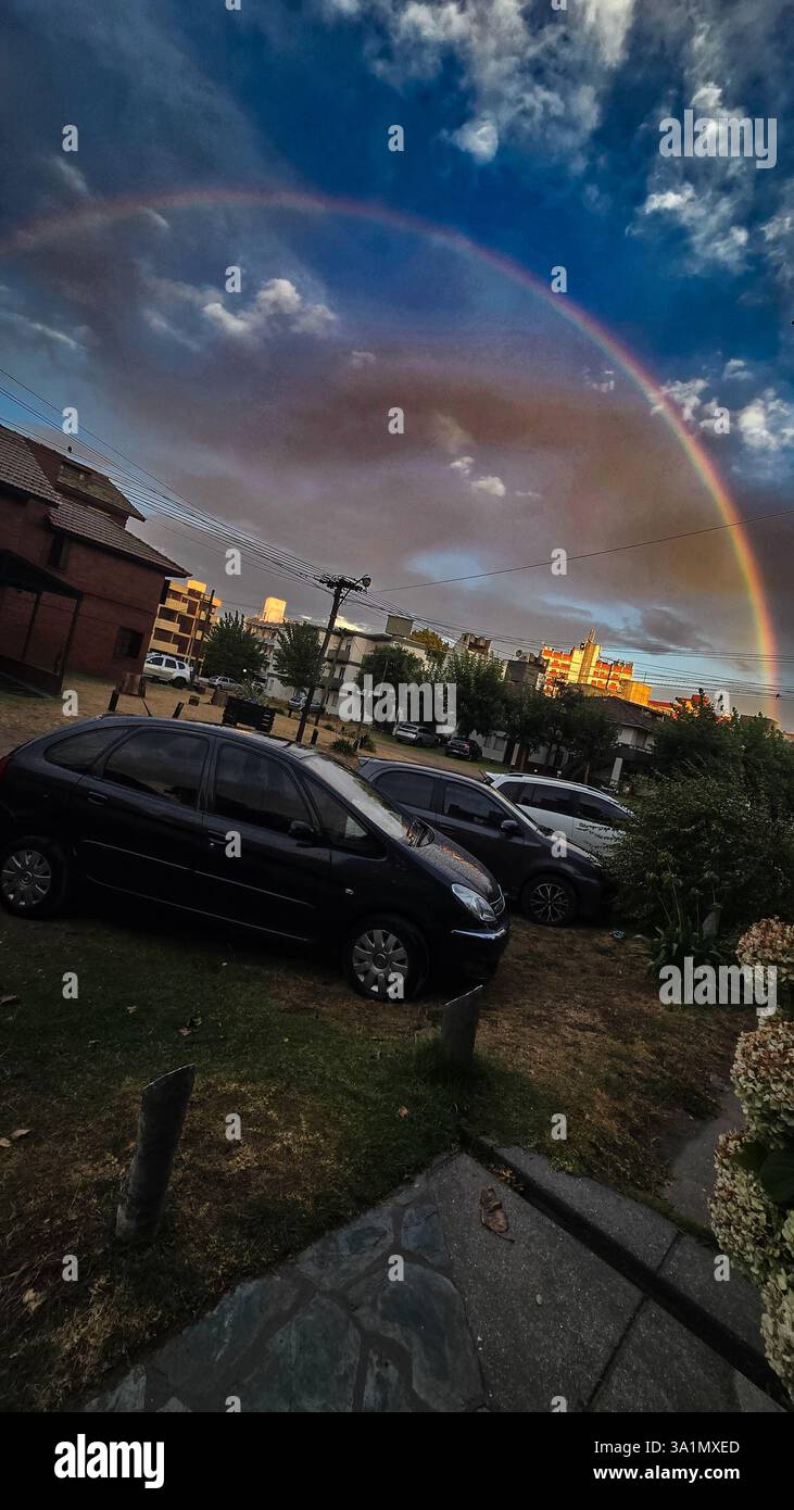 Villa Gesell, 16.02.2025: A rainbow forms in the late afternoon on the beach of Atlantic coast of the province of Buenos Aires (Néstor J. Beremblum) - Smartphone Captured Stock Image