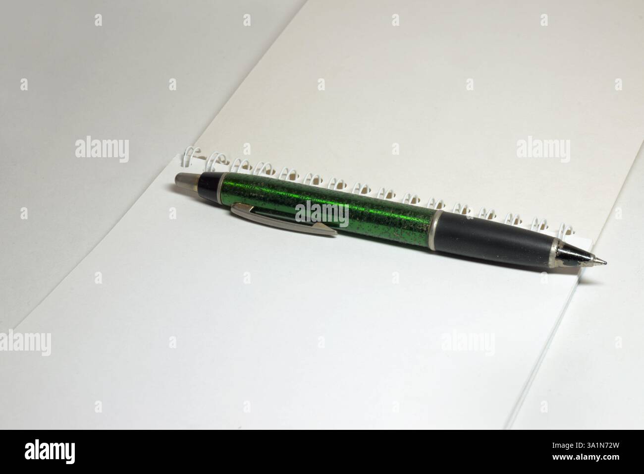 blank flip notepad on binding spring, big nice spring pen on white unlined clear pages Stock Photo