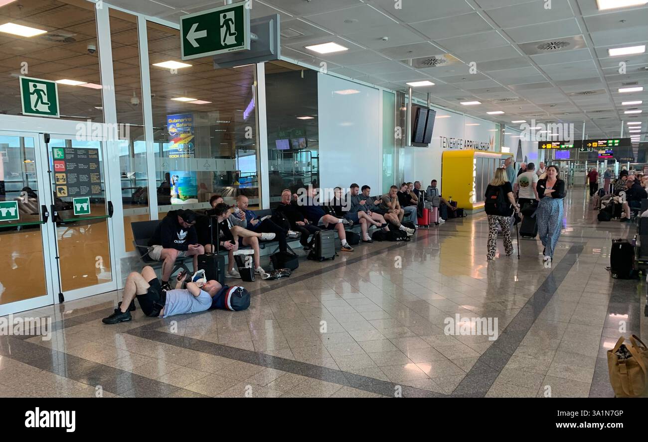 Tenerife Airport shop shopping food restaurant people sit sat floor waiting van emergency exit flying hot food beer drink signs sign VW Volkswagen - Smartphone Captured Stock Image