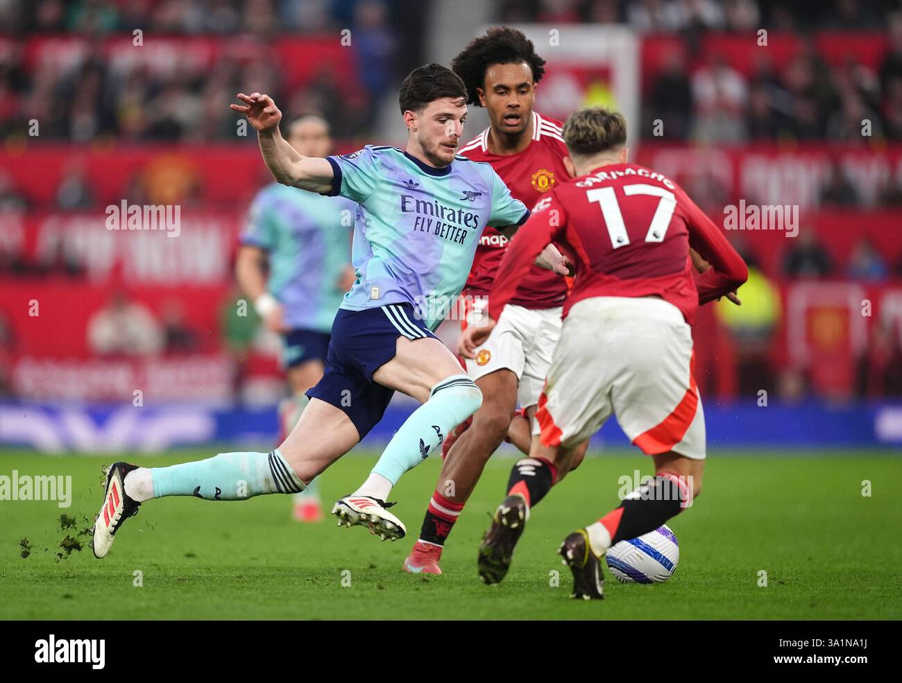 Arsenal's Declan Rice (left) battles for the ball with Manchester ...