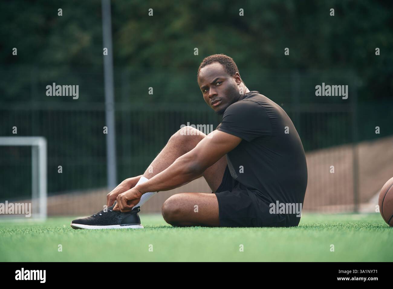 Handsome black man is posing outdoors at daytime. Stock Photo