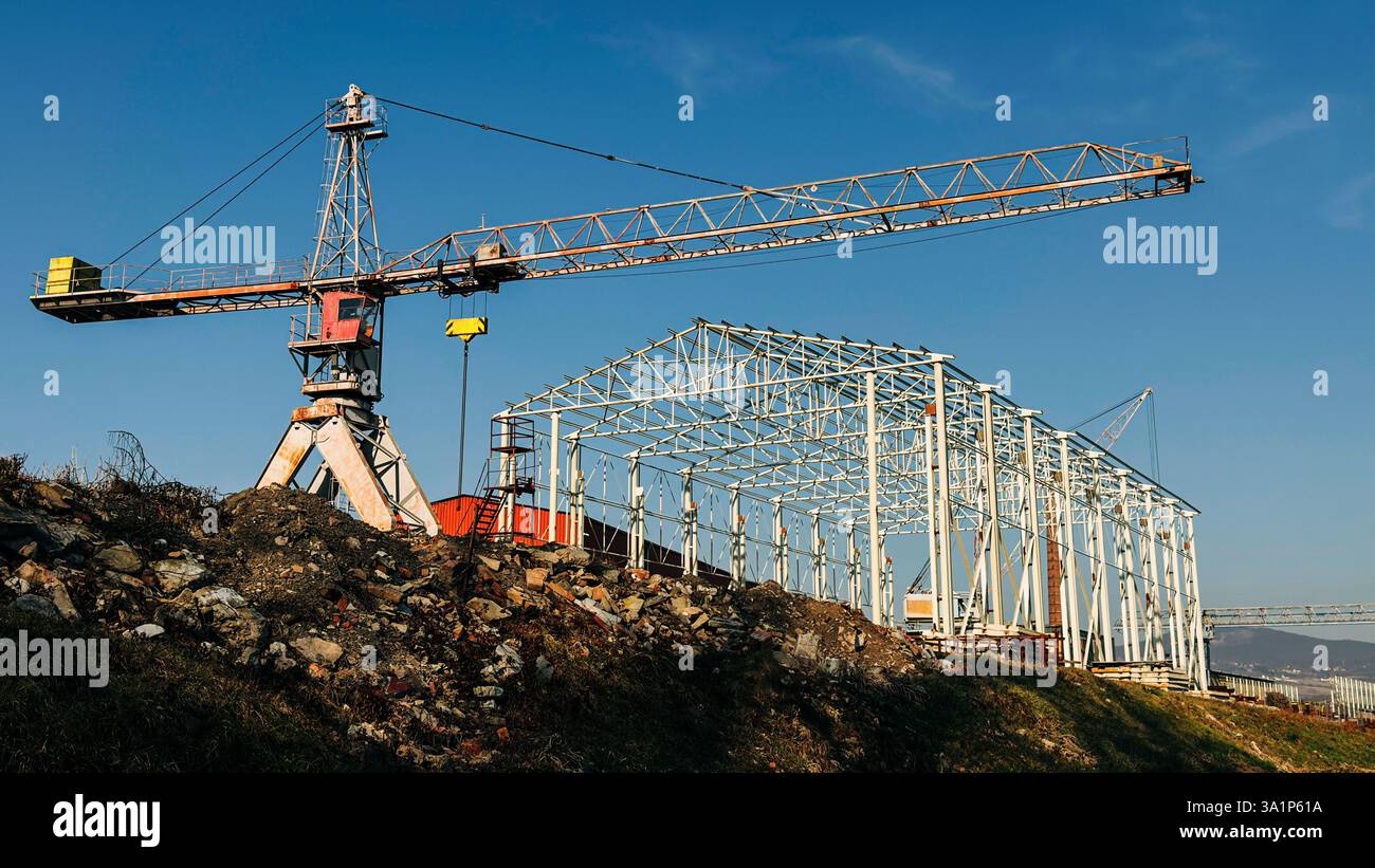 Large industrial crane at a construction site lifting materials near a ...
