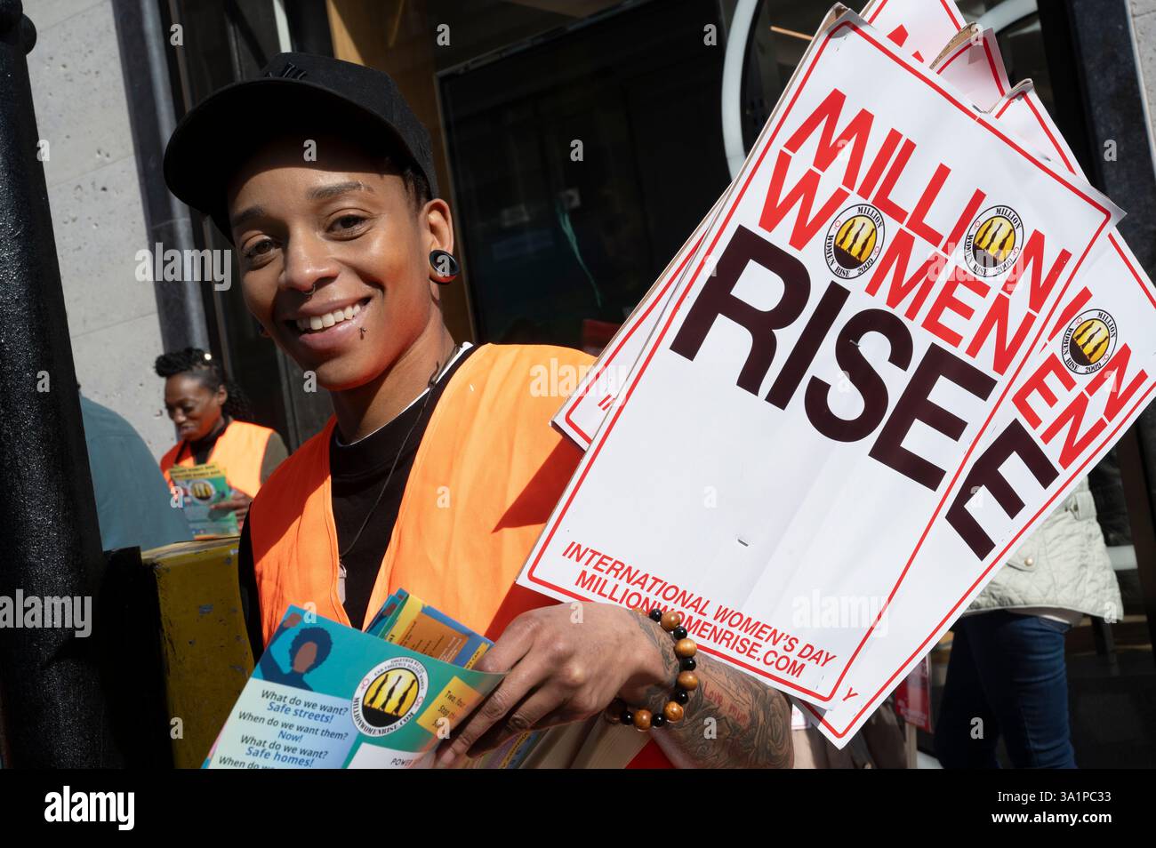 International Women's Day 2025, Central London. March  and rally organised by Million Women Rise. Steward in orange tabard. Stock Photo