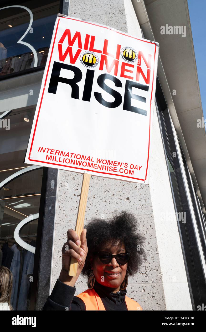 International Women's Day 2025, Central London. March  and rally organised by Million Women Rise. Steward in orange tabard. Stock Photo