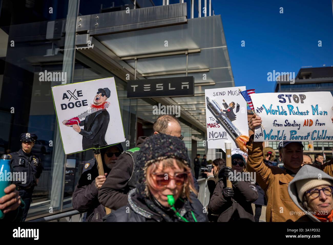 Hundreds protest outside a Tesla showroom in Manhattan. Protests ...