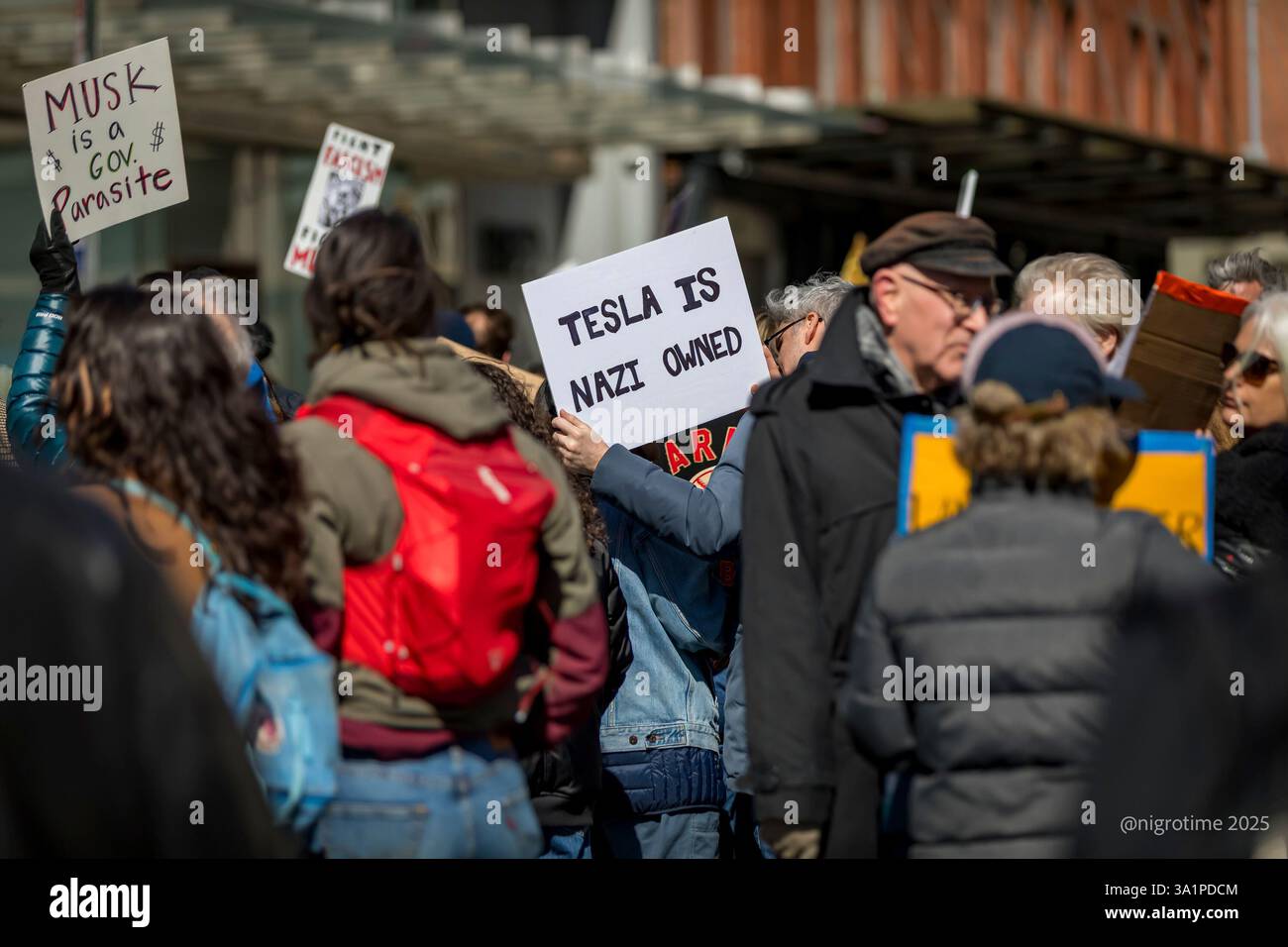 NEW YORK, NEW YORK - MARCH 8: A protestor outside a Tesla showroom in ...