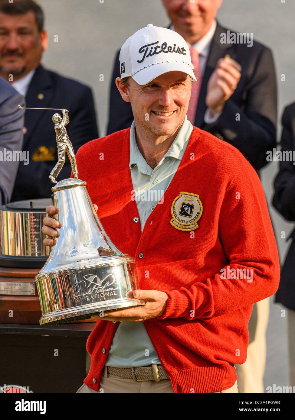 March 9, 2025 Russell Henley poses with Arnold Palmer Invitational Trophy on 18th green after