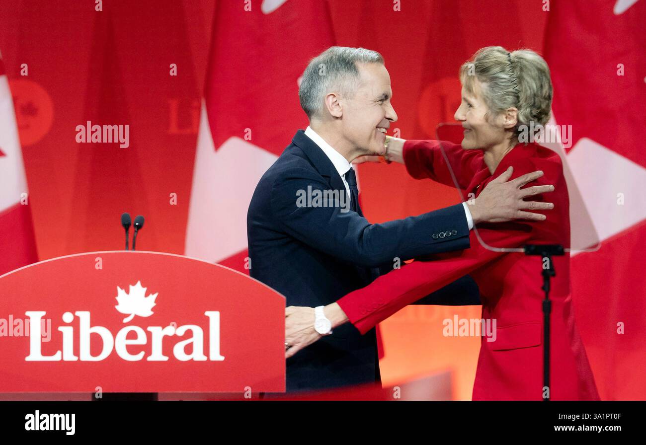 Newly appointed Liberal Leader Mark Carney hugs his wife Diana Fox