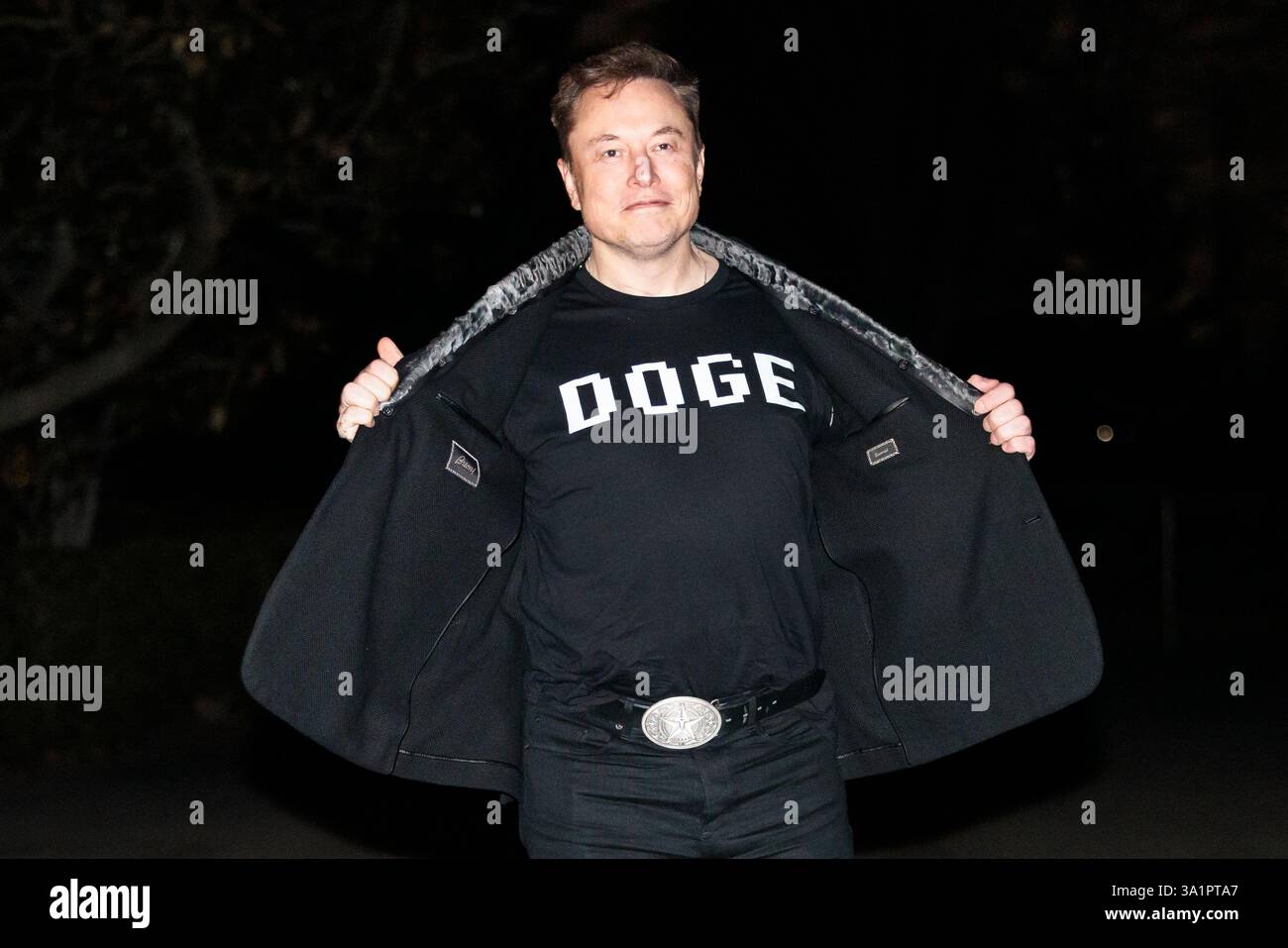 Washington DC, USA. 09th Mar, 2025. WASHINGTON – March 9, 2025: Elon Musk  reveals a DOGE t-shirt and a Tesla belt buckle before entering the White  House. Joshua Sukoff/Medill News Service Credit: