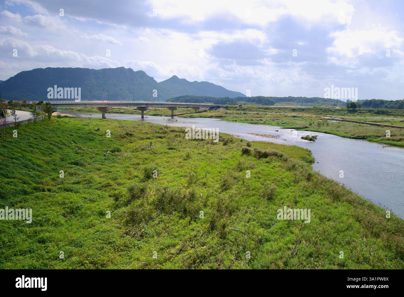 Sunchang County, South Korea - October 4, 2021: A bridge spans the Seomjin River, connecting the lush, green valley with rolling mountains in the dist Stock Photo