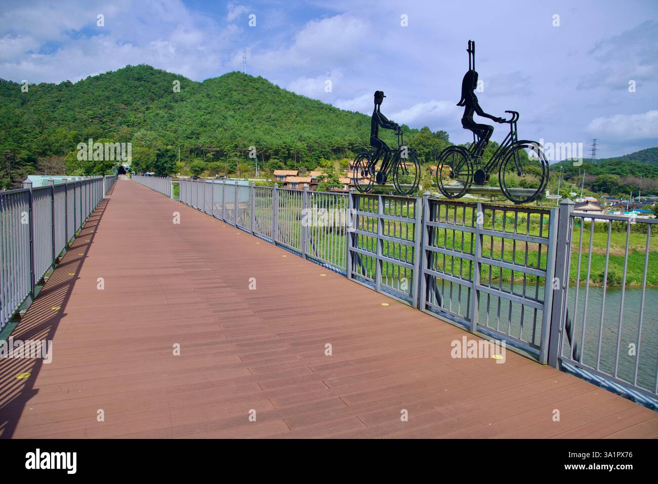 Sunchang County, South Korea - October 4, 2021: Metal sculptures of cyclists adorn the railing of Hyangga Bridge, a repurposed railway bridge now serv Stock Photo