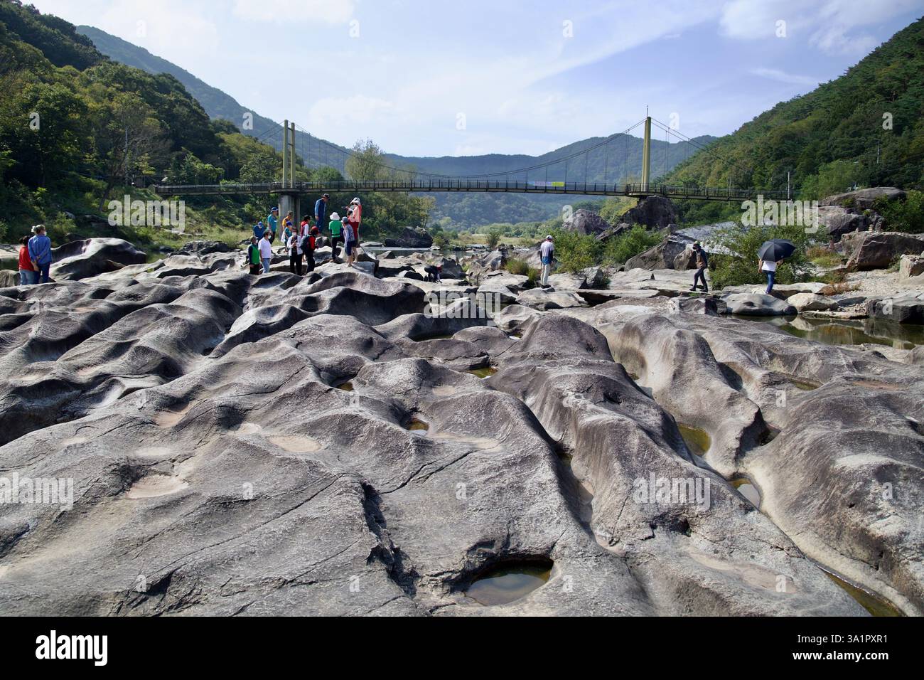 Sunchang County, South Korea - October 4, 2021: Visitors walk across the weathered rock formations at Janggunmok, shaped by centuries of erosion from Stock Photo
