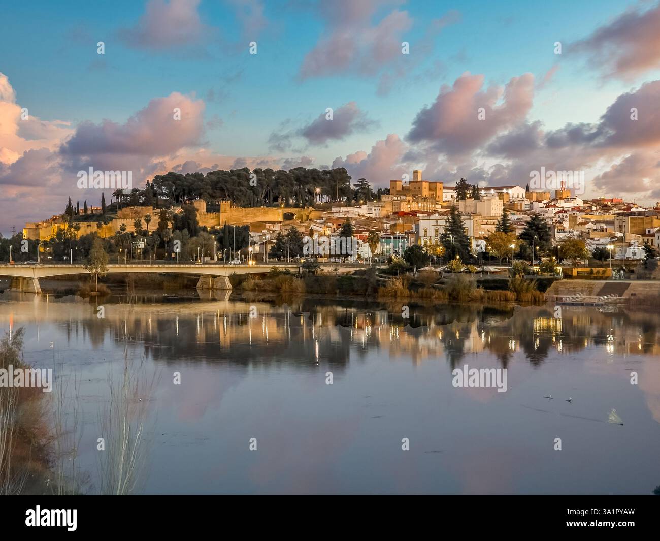 Badajoz Alcazaba palace fortress from the Islamic period reflecting on the Guadiana  river with sunset cloudy sky Stock Photo