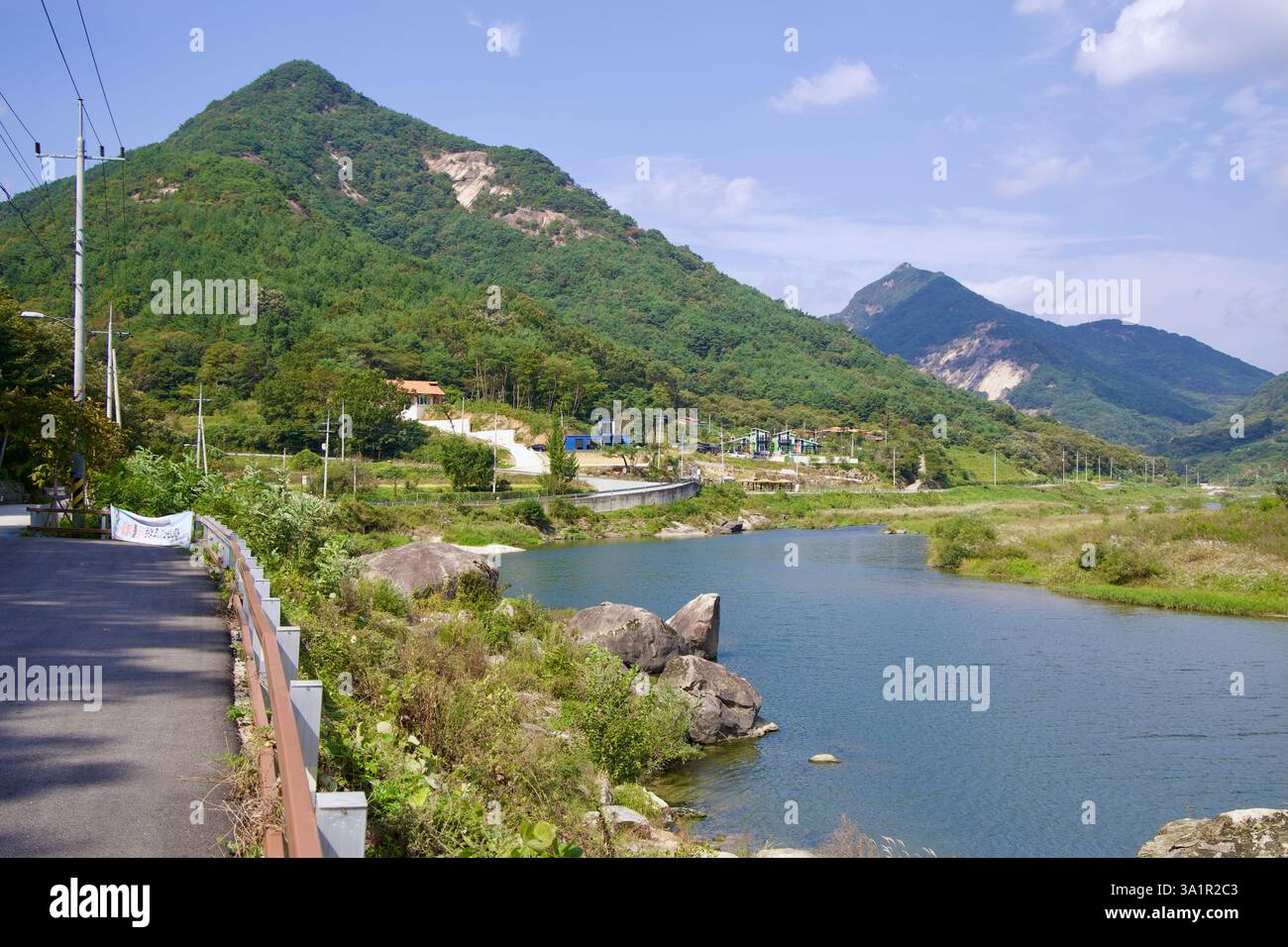 Sunchang County, South Korea - October 4, 2021: A scenic view of the Seomjin River flowing beneath the towering Muryang Mountain, with a winding cycli Stock Photo