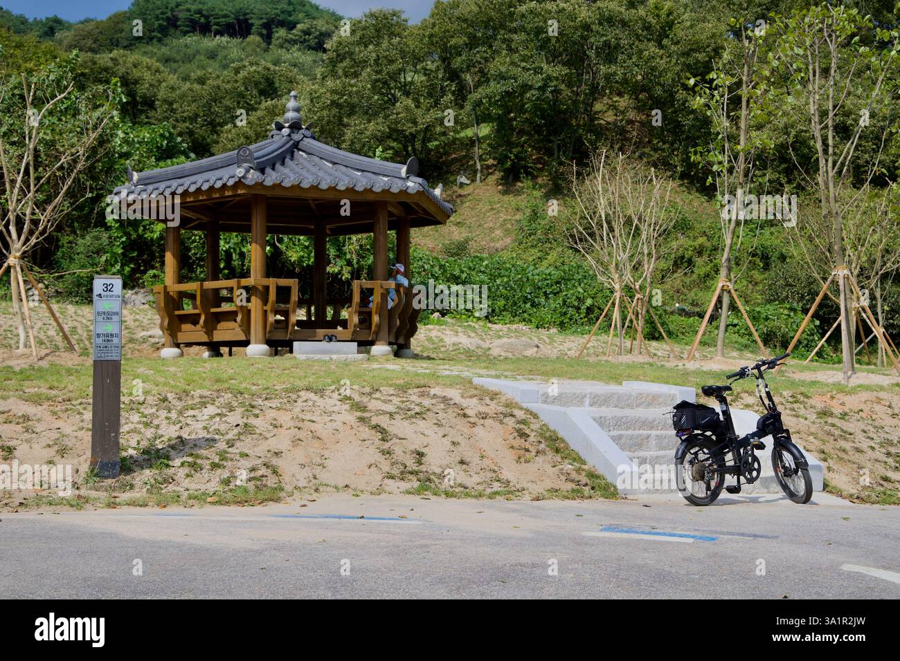 Sunchang County, South Korea - October 4, 2021: A traditional wooden rest pavilion provides shade for cyclists along the Seomjingang Bike Path, with a Stock Photo