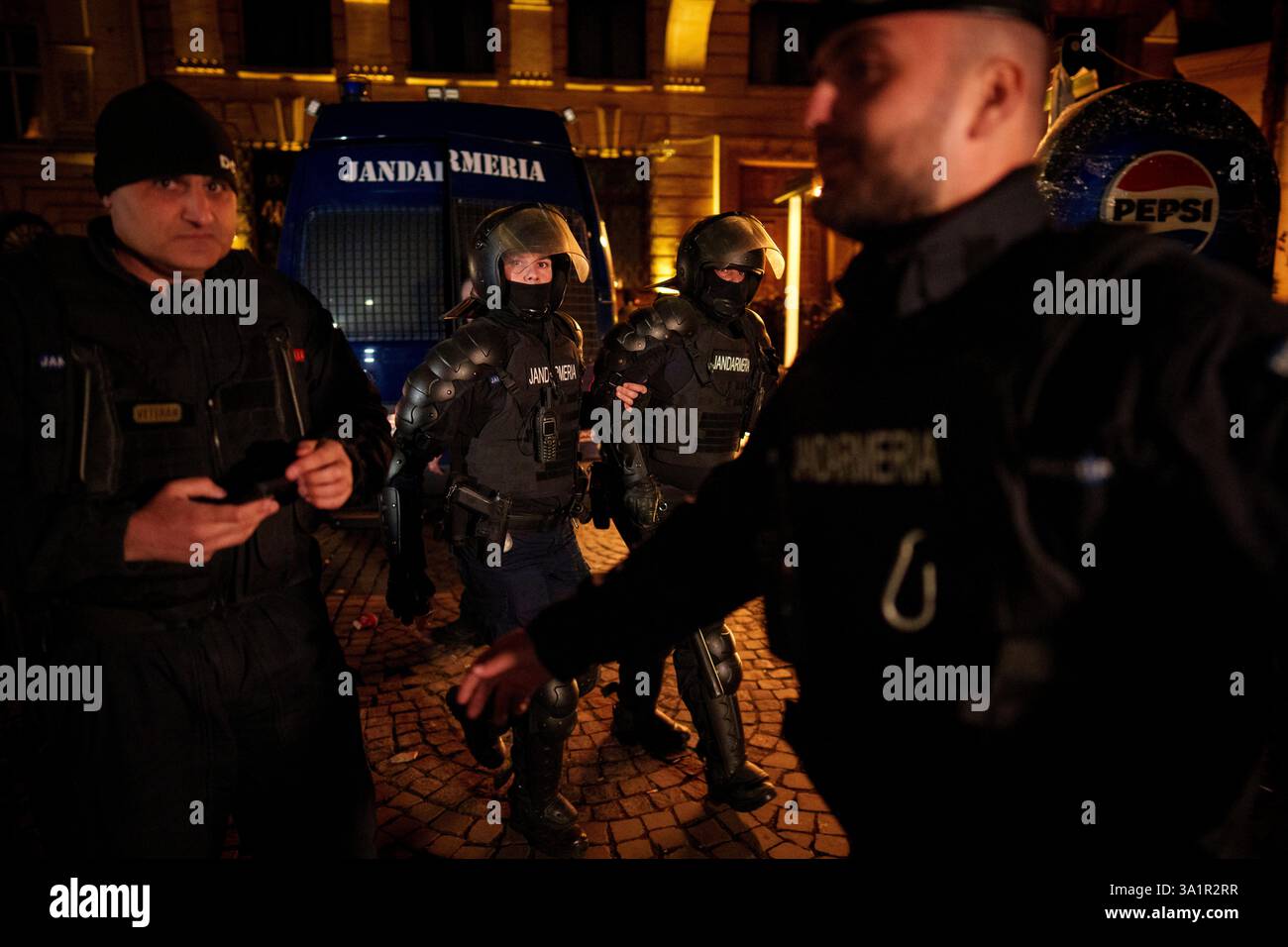 A riot policeman supports an injured colleague following clashes with ...