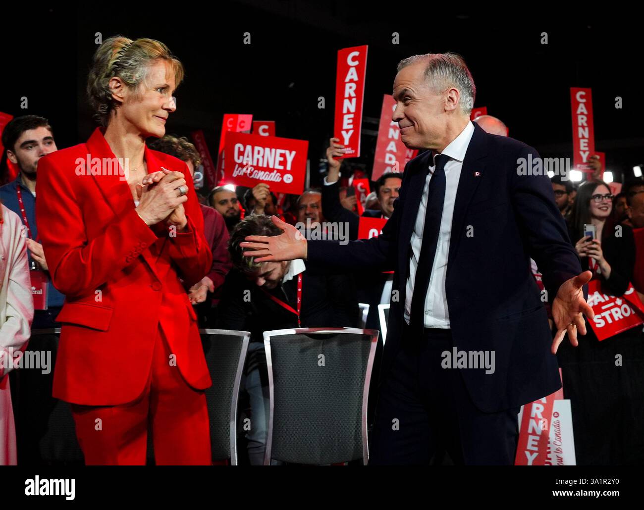 Liberal Party of Canada Leader Mark Carney reacts with his wife Diana