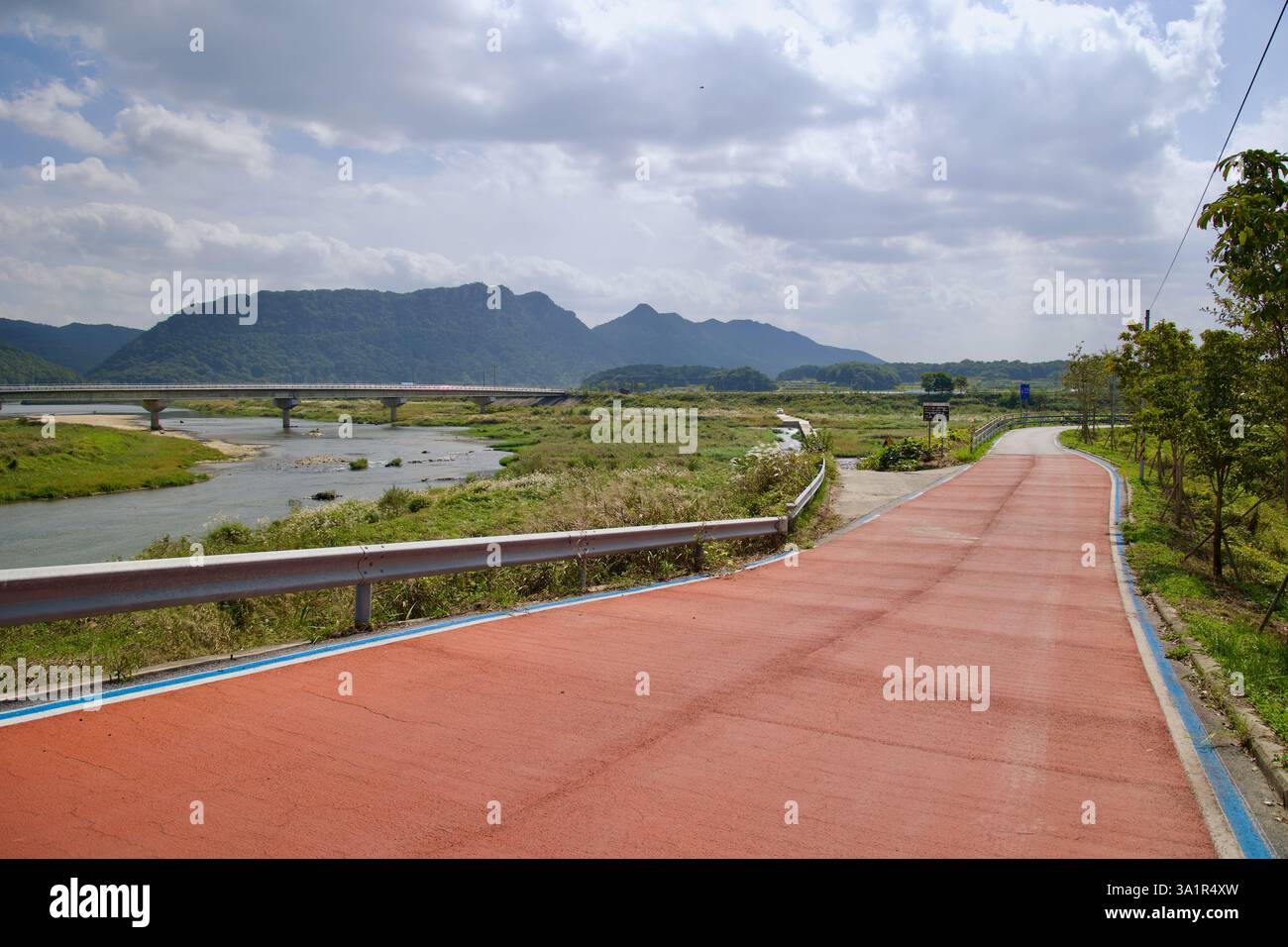 Sunchang County, South Korea - October 4, 2021: A section of the Seomjingang Bike Path, marked with a red surface, follows the Seomjin River, leading Stock Photo