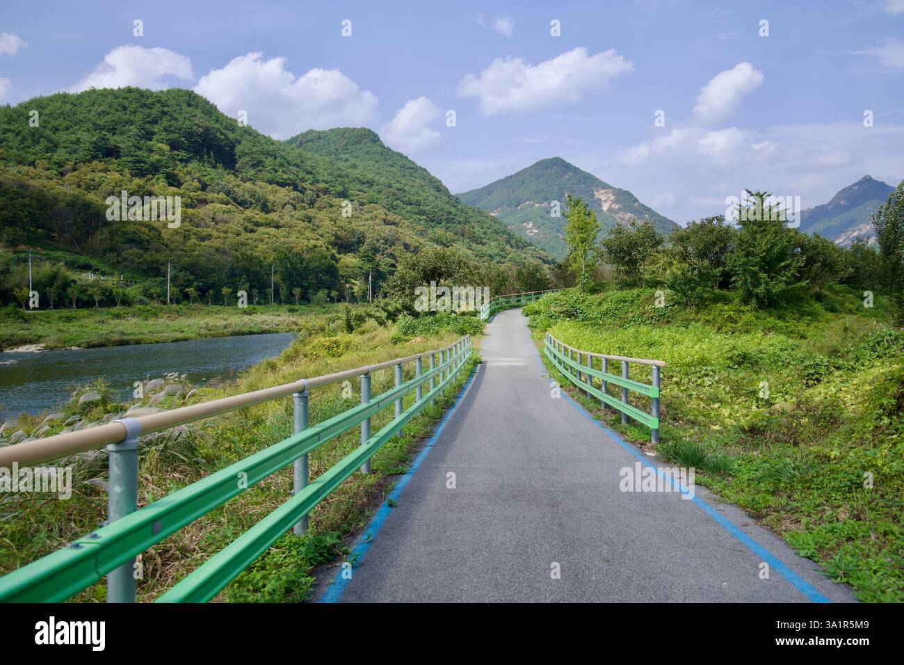 Sunchang County, South Korea - October 4, 2021: A winding section of the Seomjingang Bike Path follows the river through a lush mountain valley, offer Stock Photo