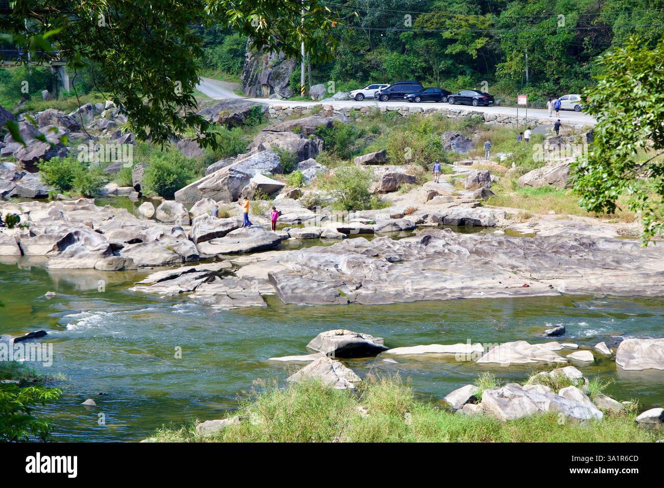 Sunchang County, South Korea - October 4, 2021: People explore the rocky riverbed of the Seomjin River at Janggunmok, wading in the shallow waters and Stock Photo