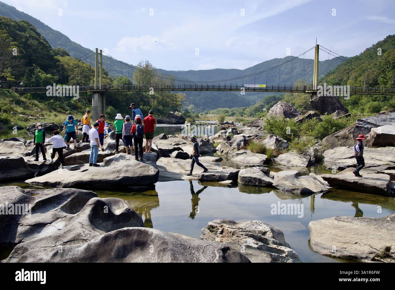 Sunchang County, South Korea - October 4, 2021: A group of visitors explores the unique rock formations at Janggunmok near the Seomjin River, with the Stock Photo