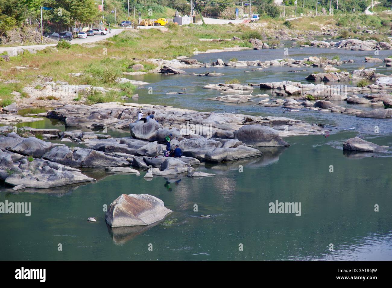 Sunchang County, South Korea - October 4, 2021: Visitors walk across the smooth, weathered rocks of Janggunmok, surrounded by the flowing waters of th Stock Photo