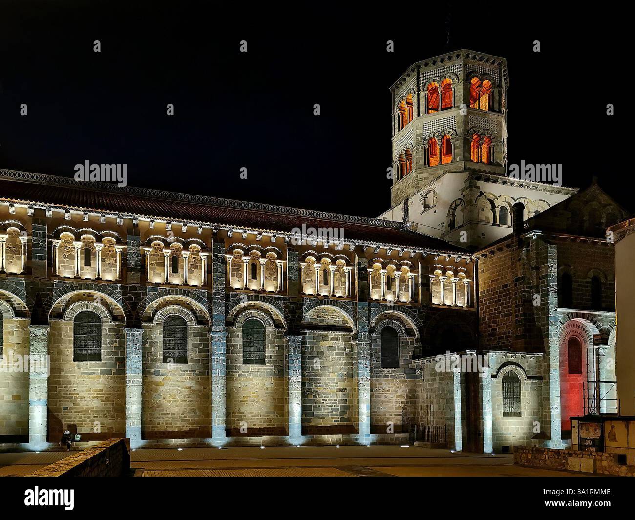 Issoire. Illuminated at night, the Abbatiale Saint Austremoine showcases its impressive Romanesque architecture. Puy de Dome. Auvergne. France - Smartphone Captured Stock Image