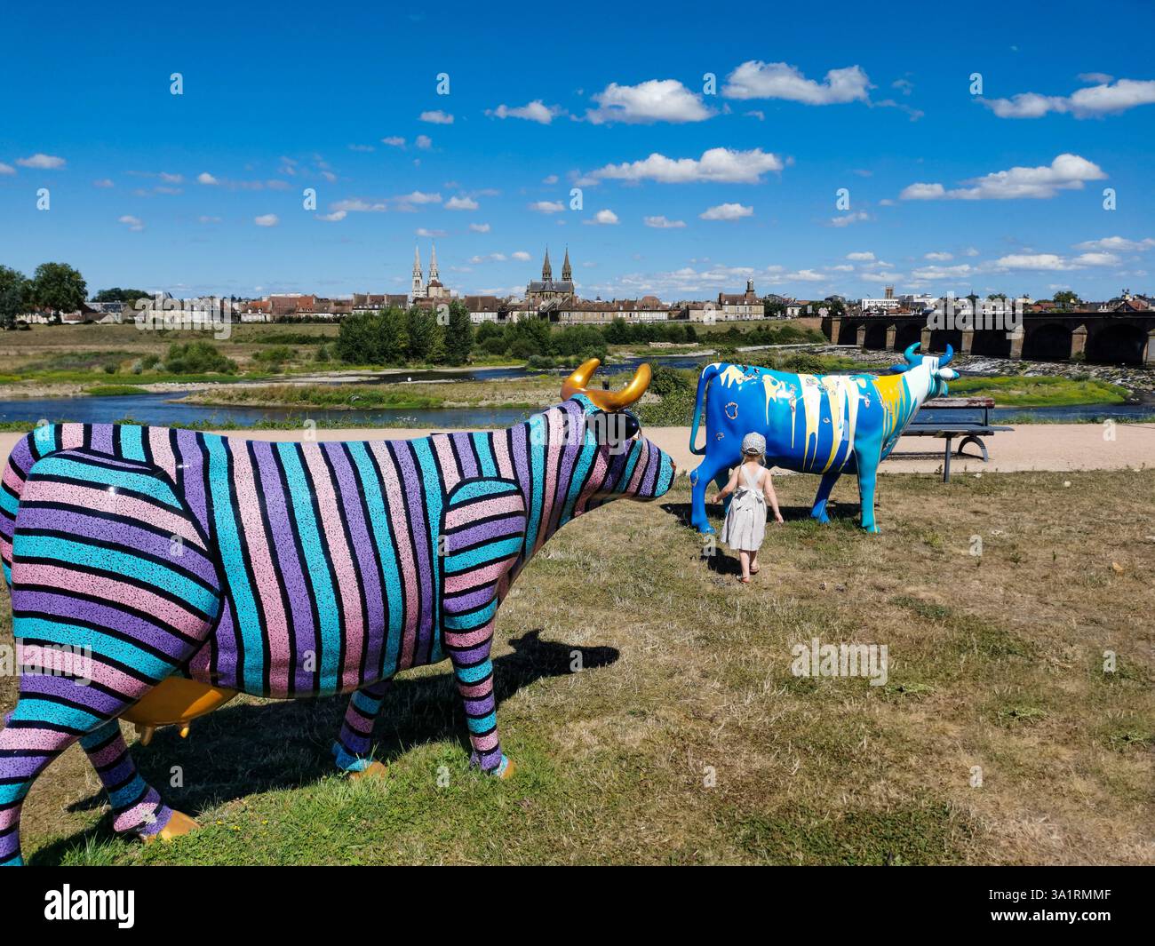 Colorfully painted fiberglass cows are displayed at the 'Oh, la vache!' exhibition in Moulins. Allier. Auvergne-Rhone-Alpes. France - Smartphone Captured Stock Image