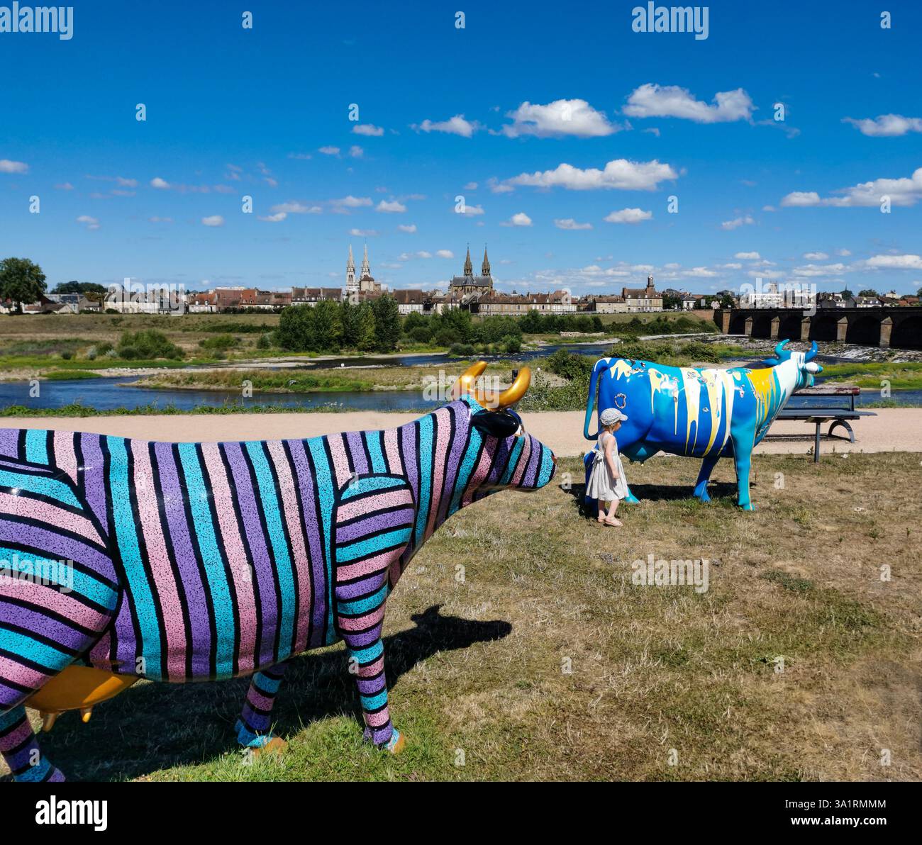 Colorfully painted fiberglass cows are displayed at the 'Oh, la vache!' exhibition in Moulins. Allier. Auvergne-Rhone-Alpes. France - Smartphone Captured Stock Image