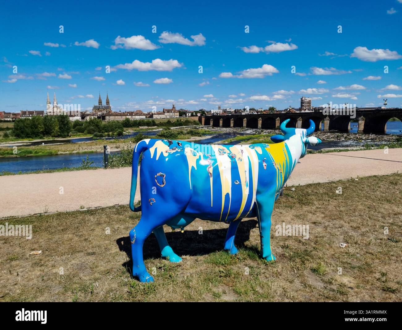 Colorfully painted fiberglass cows are displayed at the 'Oh, la vache!' exhibition in Moulins. Allier. Auvergne-Rhone-Alpes. France - Smartphone Captured Stock Image