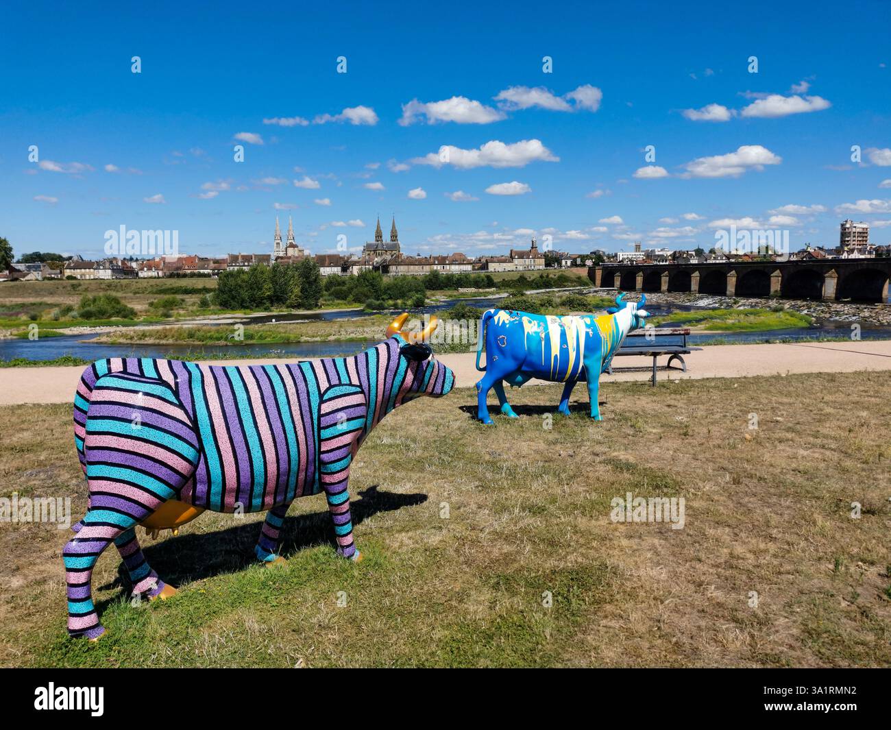 Colorfully painted fiberglass cows are displayed at the 'Oh, la vache!' exhibition in Moulins. Allier. Auvergne-Rhone-Alpes. France - Smartphone Captured Stock Image