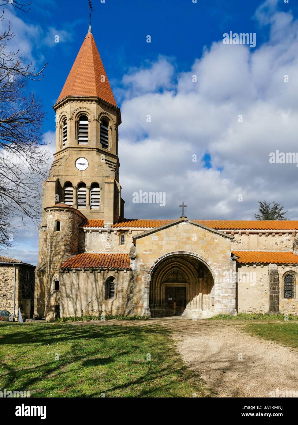 The Church Saint-Nicolas of Nonette showcases against a backdrop of fluffy clouds and expansive blue sky. Puy de Dome. Auvergne-Rhone-Alpes. France - Smartphone Captured Stock Image
