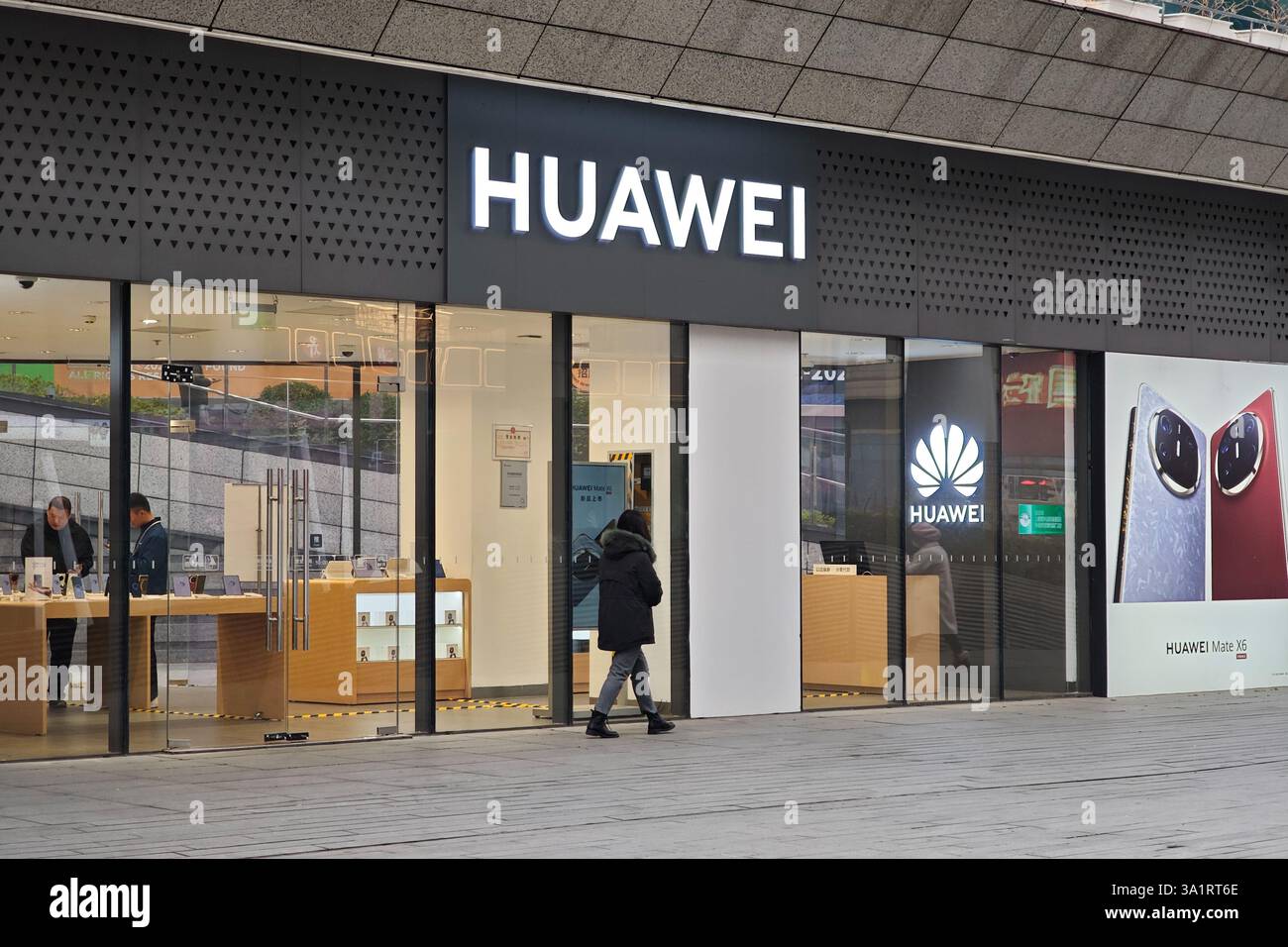 SHANGHAI, CHINA - MARCH 10, 2025 - A pedestrian passes a Huawei store