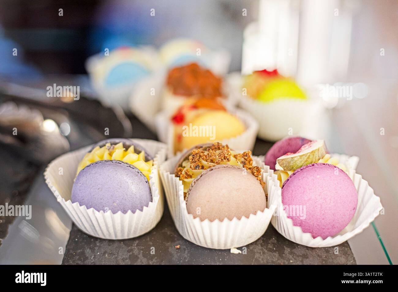 multicolored macaroons with filling in a bakery Stock Photo
