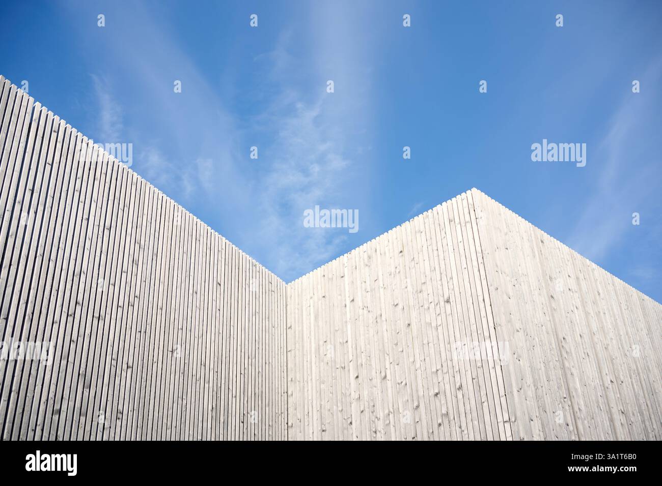 Modern wooden building facade with blue sky background Stock Photo - Alamy