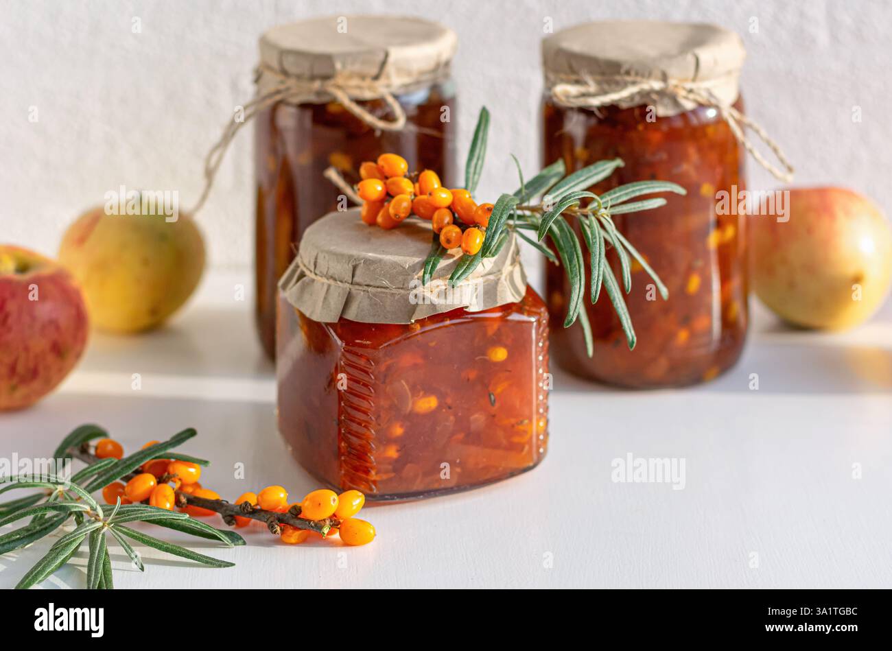 A collection of jars filled with golden seabuckthorn and apple jam. Close-up. Stock Photo