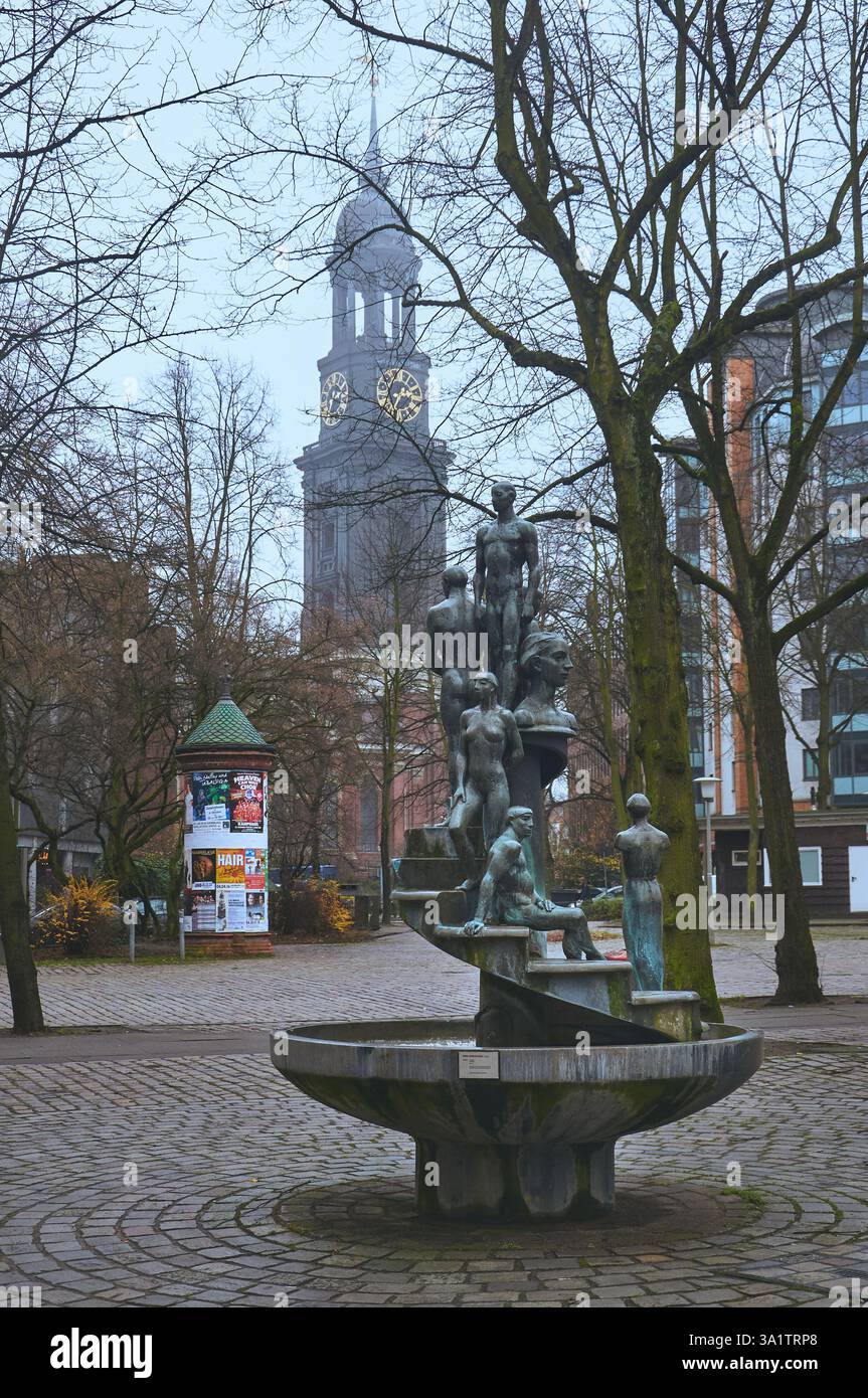Hamburg, Germany - 12.07.2015 A stunning fountain with sculptures in the foreground and St. Michael’s Church tower behind Stock Photo