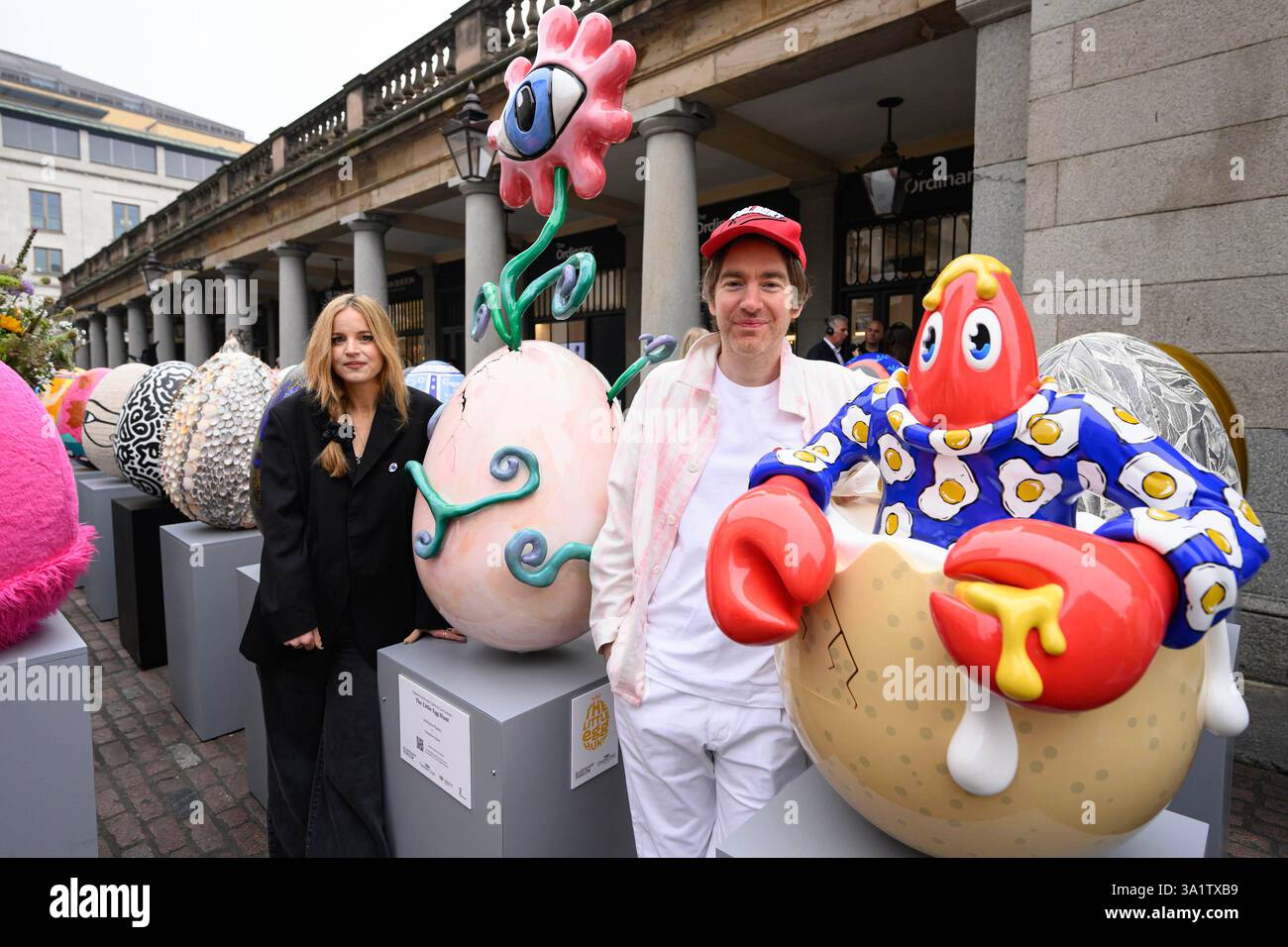 EDITORIAL USE ONLY Charlotte Colbert and Philip Colbert with their egg sculpture, which is one of 100 egg sculptures, on display in London's Covent Garden before being dotted across the capital for the Elephant Family Charity's 'The Big Egg Hunt', in partnership with Clarence Court Eggs. Picture date: Monday March 10, 2025. Stock Photo
