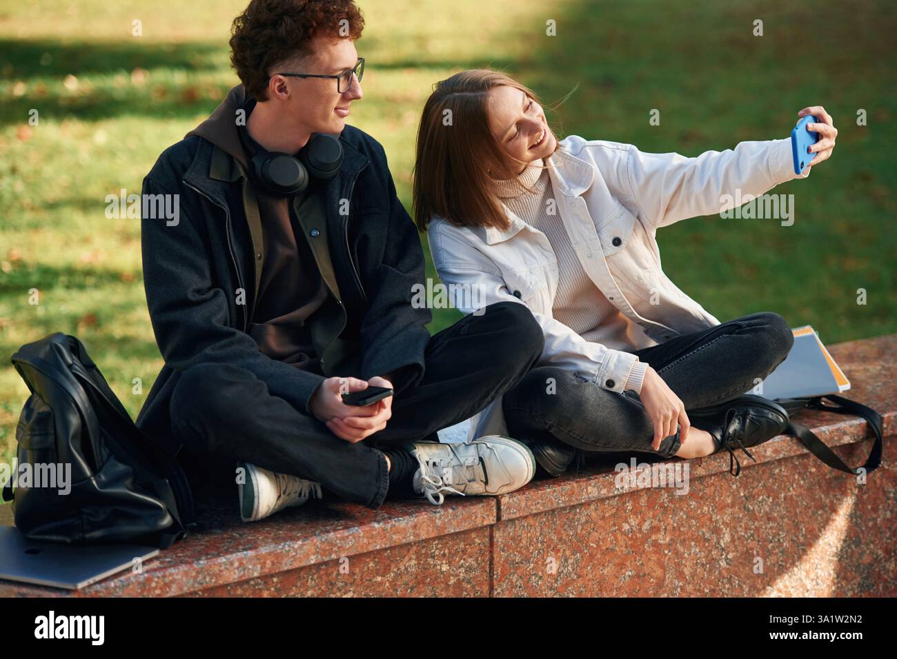 Taking a selfie. Two young students are together outdoors. Stock Photo